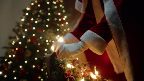 Santa Sorting Festive Holiday Gifts by Christmas Tree