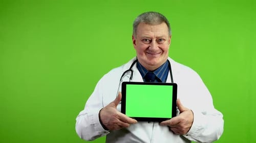 Smiling Doctor Holding Tablet with Green Screen Display
