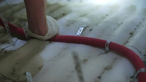 Orange Tubing Installed with Nail Gun on Floor