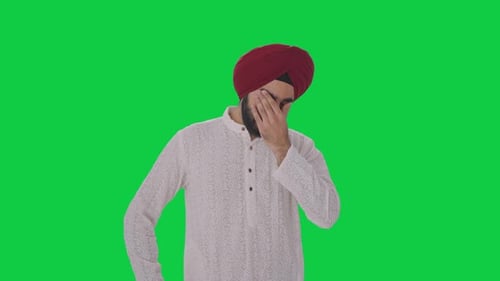 Sick Sikh Indian man suffering from headache Green screen