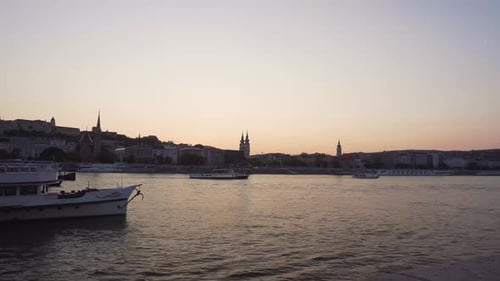 Boat passing under a bridge at night in Budapest, Hungary