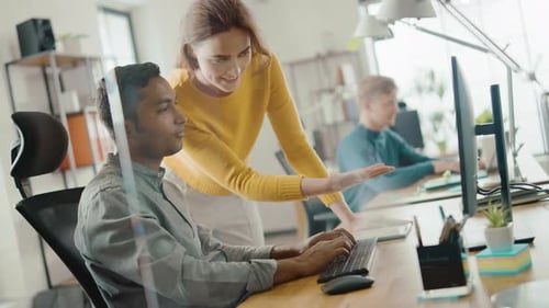 Man Types as Colleague Explains at Computer