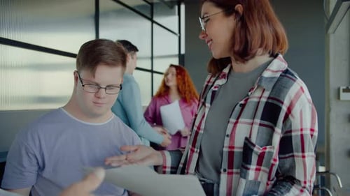 Diverse Team Discusses Documents in Modern Office