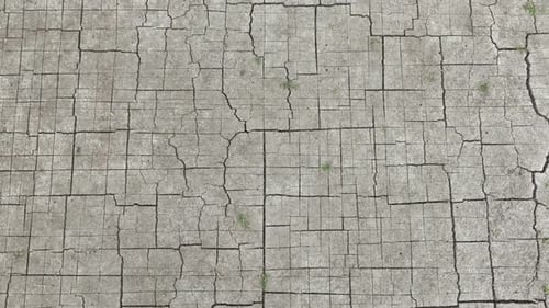 Aerial drone view of cracked dry soil forming geometric patterns.