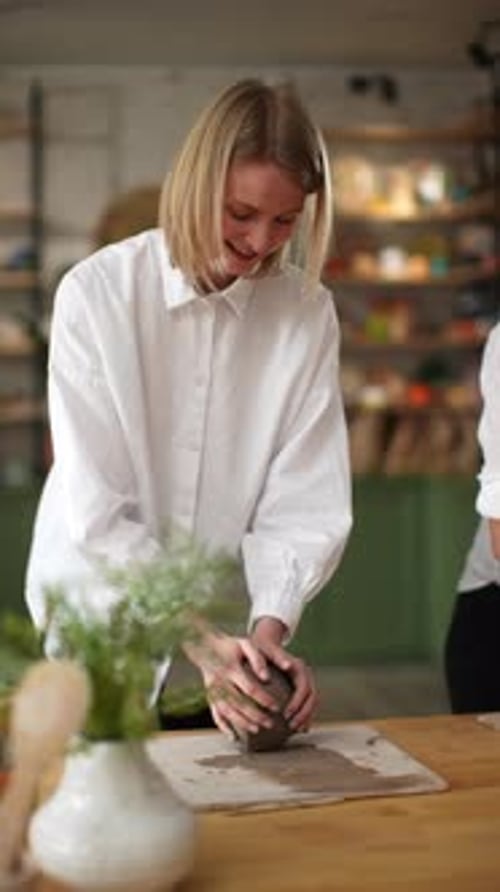 Woman Shaping Clay in an Art Studio