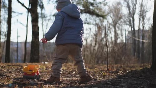 Happy Baby Child Outdoor Little Toddler Boy with Toy Car Having Fun on Walk in Park Baby Son Smiling