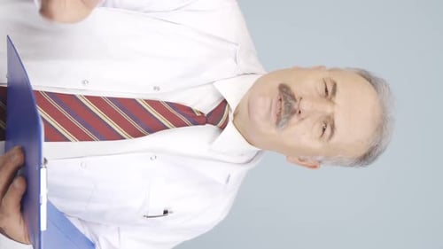 Doctor in Lab Coat Writing on Clipboard