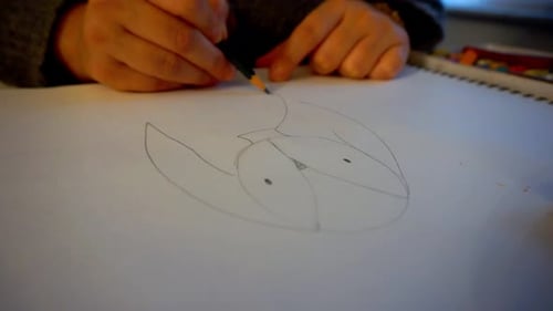 Hands Drawing an Illustration with Pencil on Paper