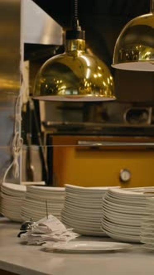 Vertical of Restaurant Kitchen with Plates and Kitchen Tools