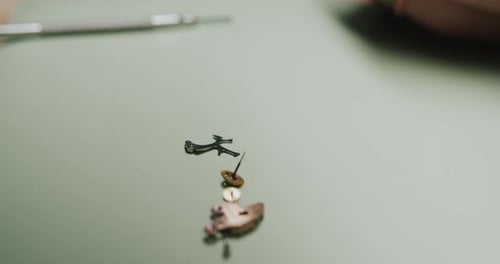 A watchmaker disassembling the parts of a wristwatch for repairing and cleaning - close up