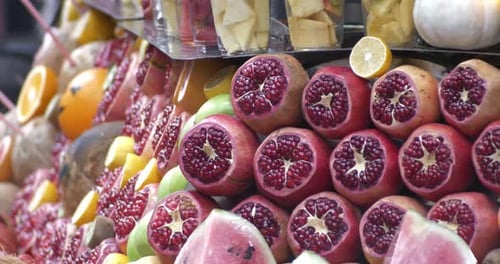 Showcase with Ripe Fruits and Berries at the Market Pomegranates and Lemons Watermelon Parts