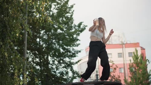 Female Performer Dances Freely on Park Picnic Table During Daytime Energetic Young Woman with