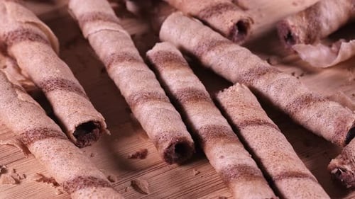 Chocolate Rolled Wafers on Wooden Surface