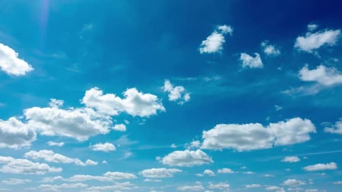Blue Sky with White Clouds. Puffy Fluffy White Clouds Moving Fast. Cumulus Cloudscape Timelapse