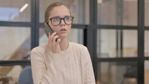 Young Woman Using Smartphone to Make a Call