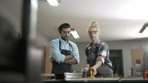 Carpenters are working together at workshop.