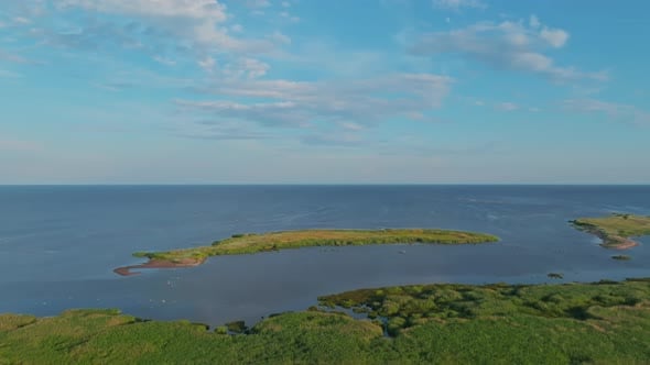 Two islets near the coast in summer sun, flying over forest, peaceful ...