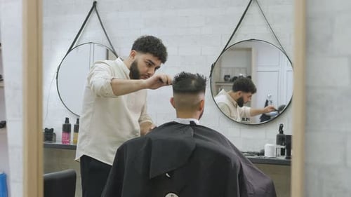 Barber Giving Haircut to Customer in Barbershop