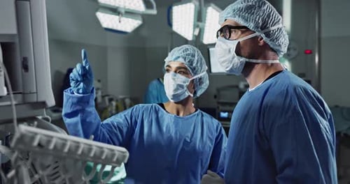 Medical team, people and doctor in operating room to talk, strategy and pointing at screen