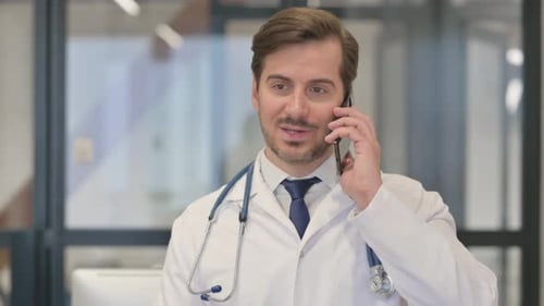 Doctor Talking on Cellphone in Hospital