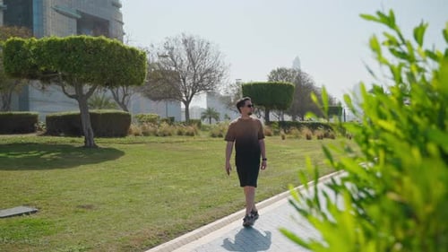 Adult Man Walking in Park Area in Megapolis in Summer Sunny Day Fulllenght Portrait of Passerby