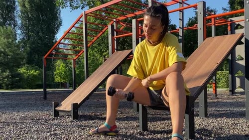 Young woman partakes empowering morning strength exercise in park