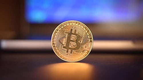 Close Up of Shiny Gold Bitcoin on Surface