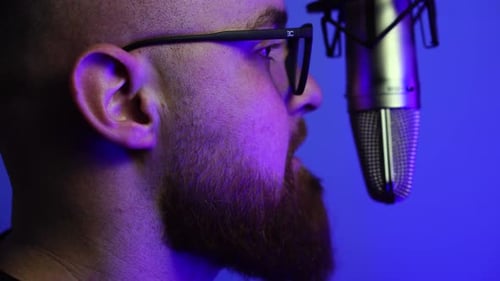 Man With Beard and Glasses Talking in Front of Studio Microphone, Podcast or Radio Talk Show