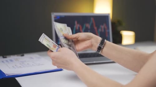 Counting Cash with Stock Market Chart Background