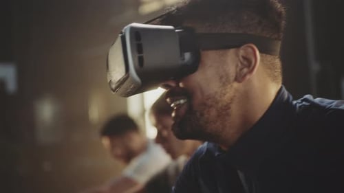 Man Wearing VR Headset Exercising on Bike