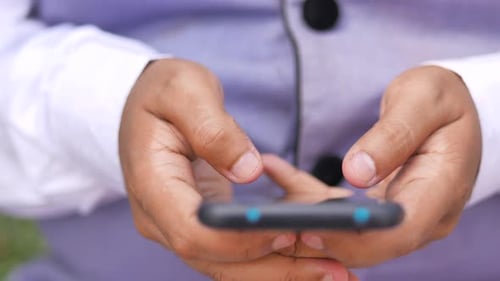 Close Up of Young Man Hand Using Smart Phone