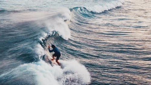 Wave Surfing Aerial Man Surfs the Wave in the Maldives