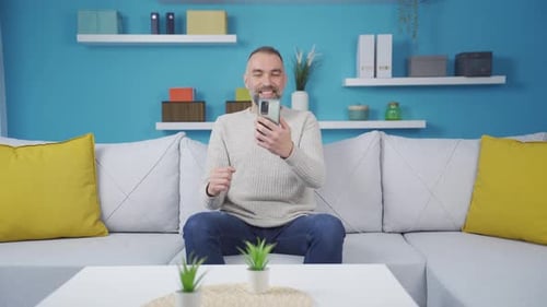 The man who happily puts the phone to his heart.