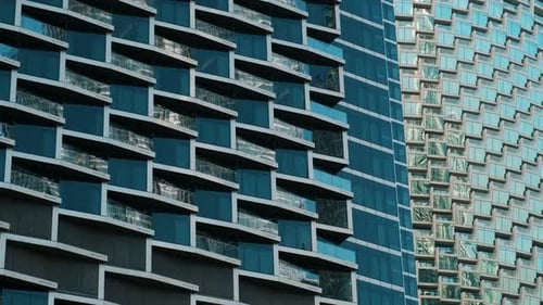 Closeup of Contemporary Glass Building Facades with Reflections Showcasing Modern Urban Architecture