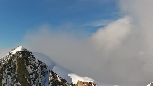 Snowy Mountain Peaks Above The Clouds. British Columbia, Canada.