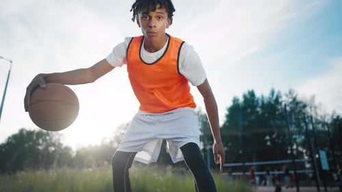 Active Sport and Healthy Lifestyle Black Teen Boy Training on Basketball Court Motivated Young