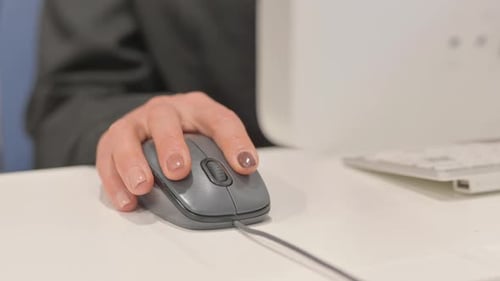 Hand Using Computer Mouse at Desk