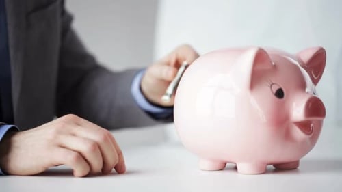 Businessman securing financial future savings investing money into piggy bank