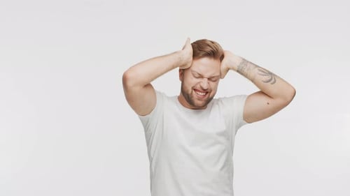 Expressive Young Man Having Pain Over Vibrant Background Studio Portrait of Handsome Person