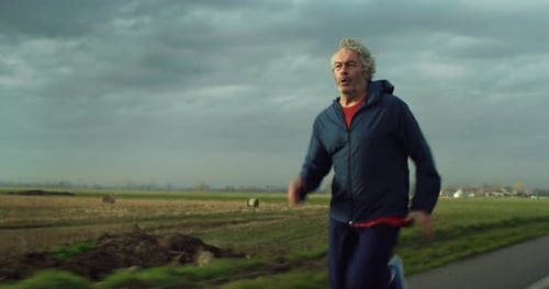 Senior Man Running on Rural Road for Fitness