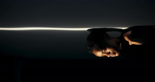 Man's Face Lit Dramatically in Dark Studio