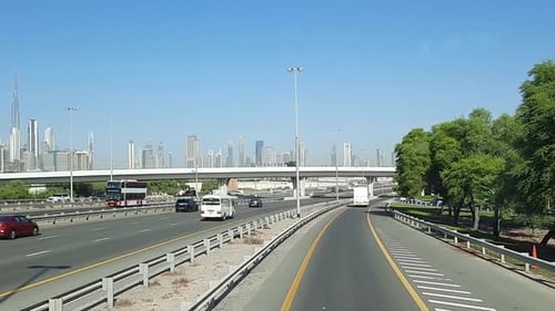 Road to the Bur Dubai expressway, skyscrapers high rise buildings in the background as getting close
