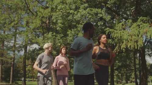 Multiracial Friends Jogging Together in Park