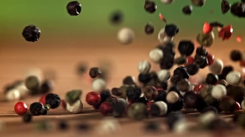 Multi-Colored Peppercorns Falling in Slow Motion