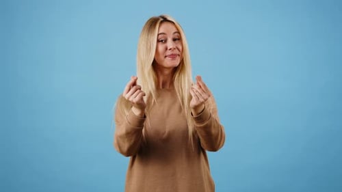 Blonde Woman Gestures Heart and Blows Kiss