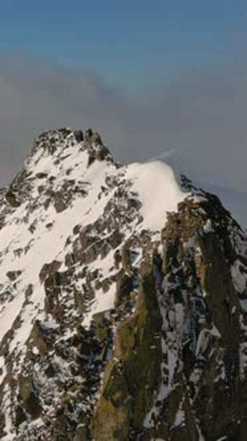 Snowy Mountain Peak Above The Clouds. British Columbia, Canada.