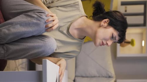Distressed Woman Experiencing Pain at Home