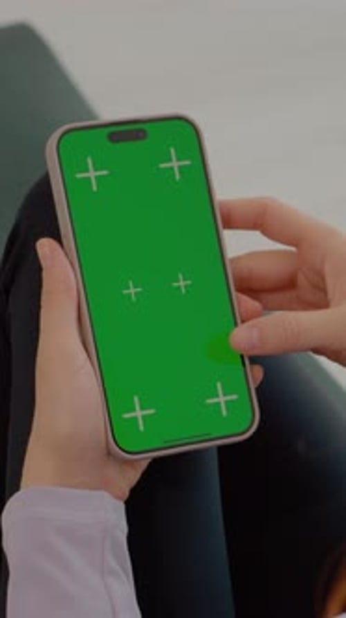 Vertical video Woman in gym mat uses green screen smartphone during fitness break