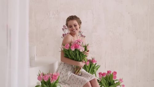 Smiling Woman with Pink Tulips Bouquet Indoors