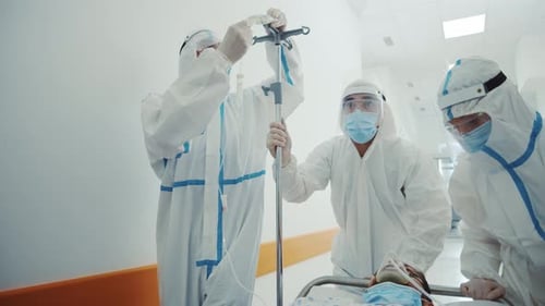 Medical Team Move Patient in Hospital Gurney